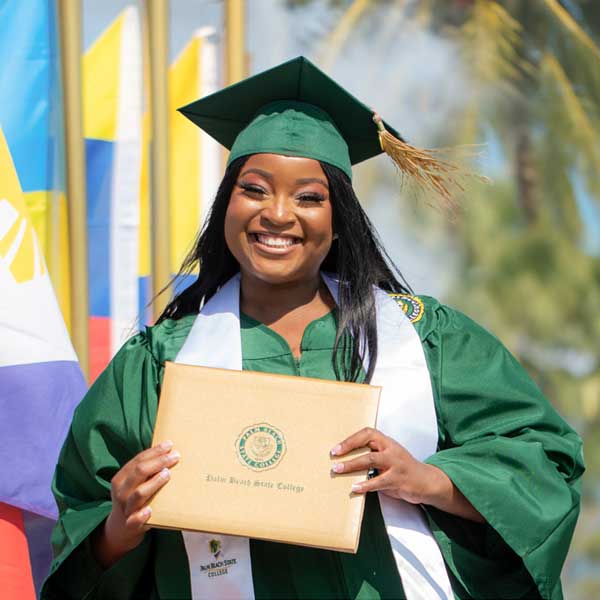 PBSC student at graduation holding diploma