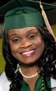 Closeup photo of a PBSC graduate wearing cap and gown